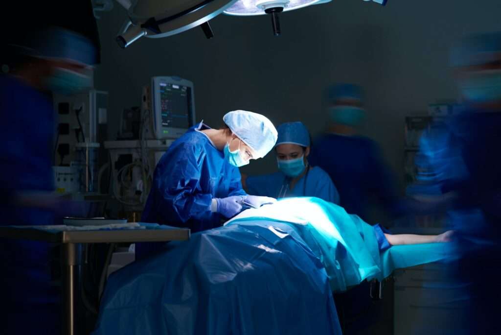 Dark operating room and hospital staff